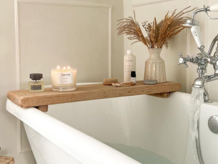 Neom candle on bath caddy