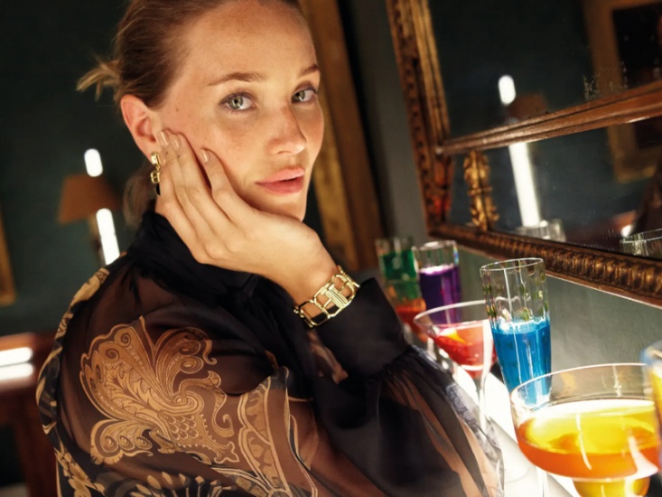 Woman sitting with several cocktails in front of her