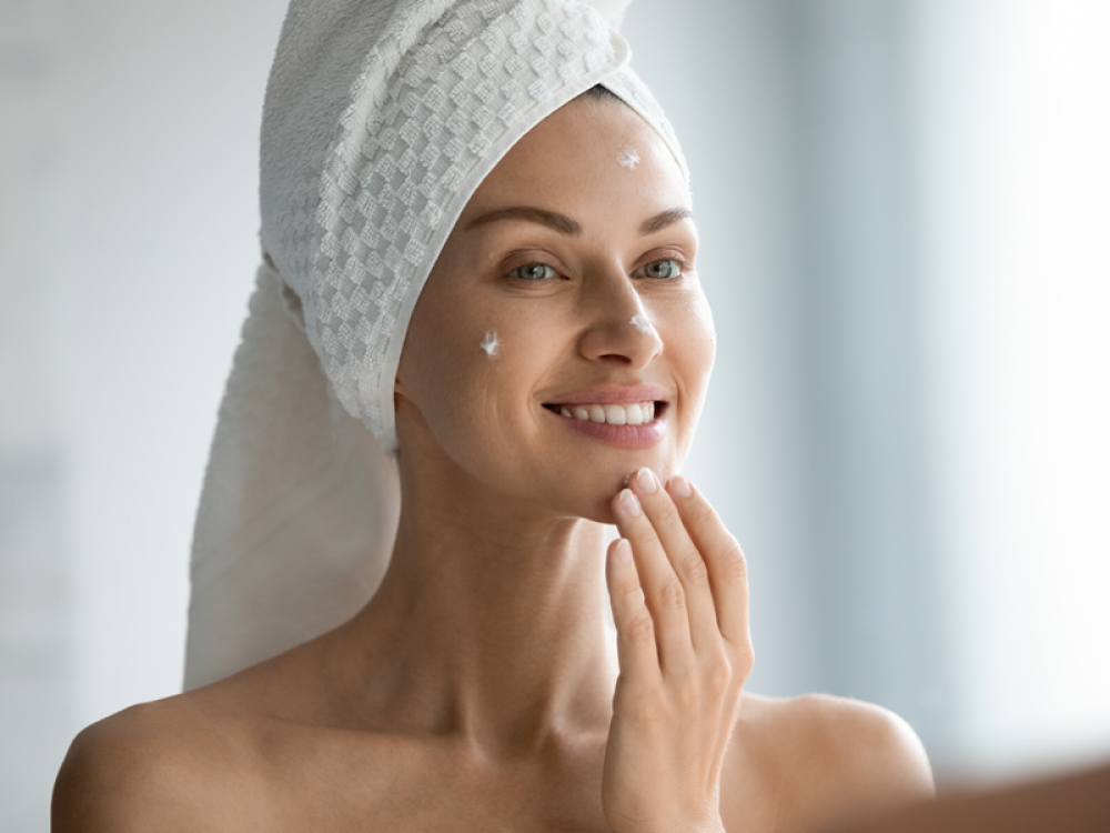 model rubbing cream on to cheekbone