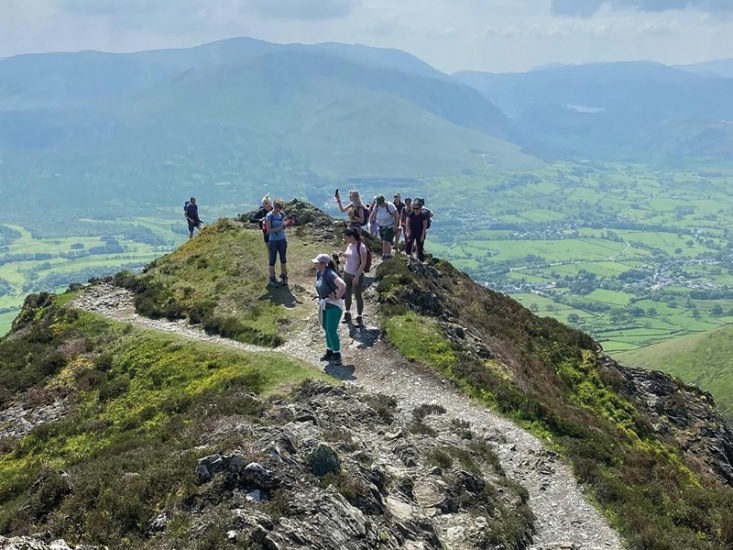 Group of women hiking on top of a hill