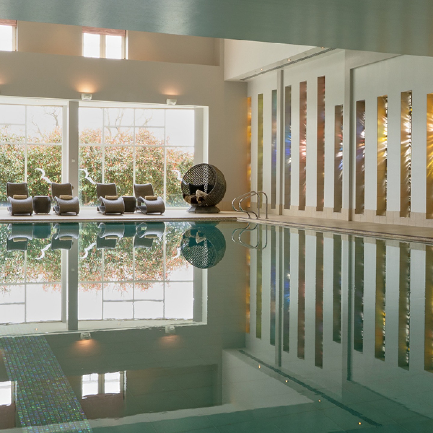 Spa pool with light shining through stain glass windows