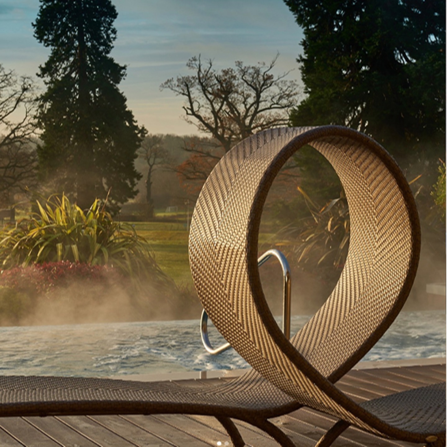 contemporary sun lounger for 2 beside a heated pool