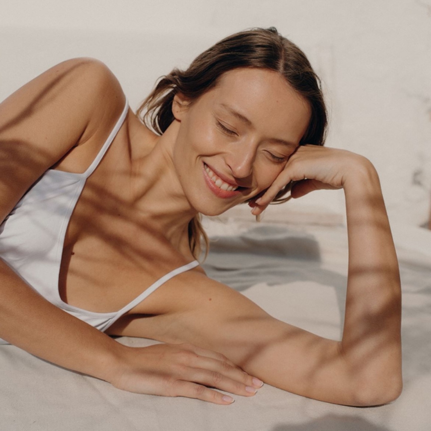 Model resting her head to her hand with a relaxed face and eyes closed