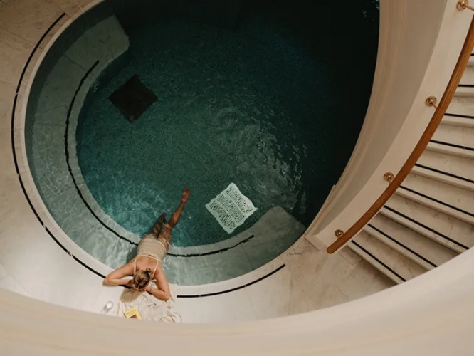 Woman baking in pool at Estelle Manor