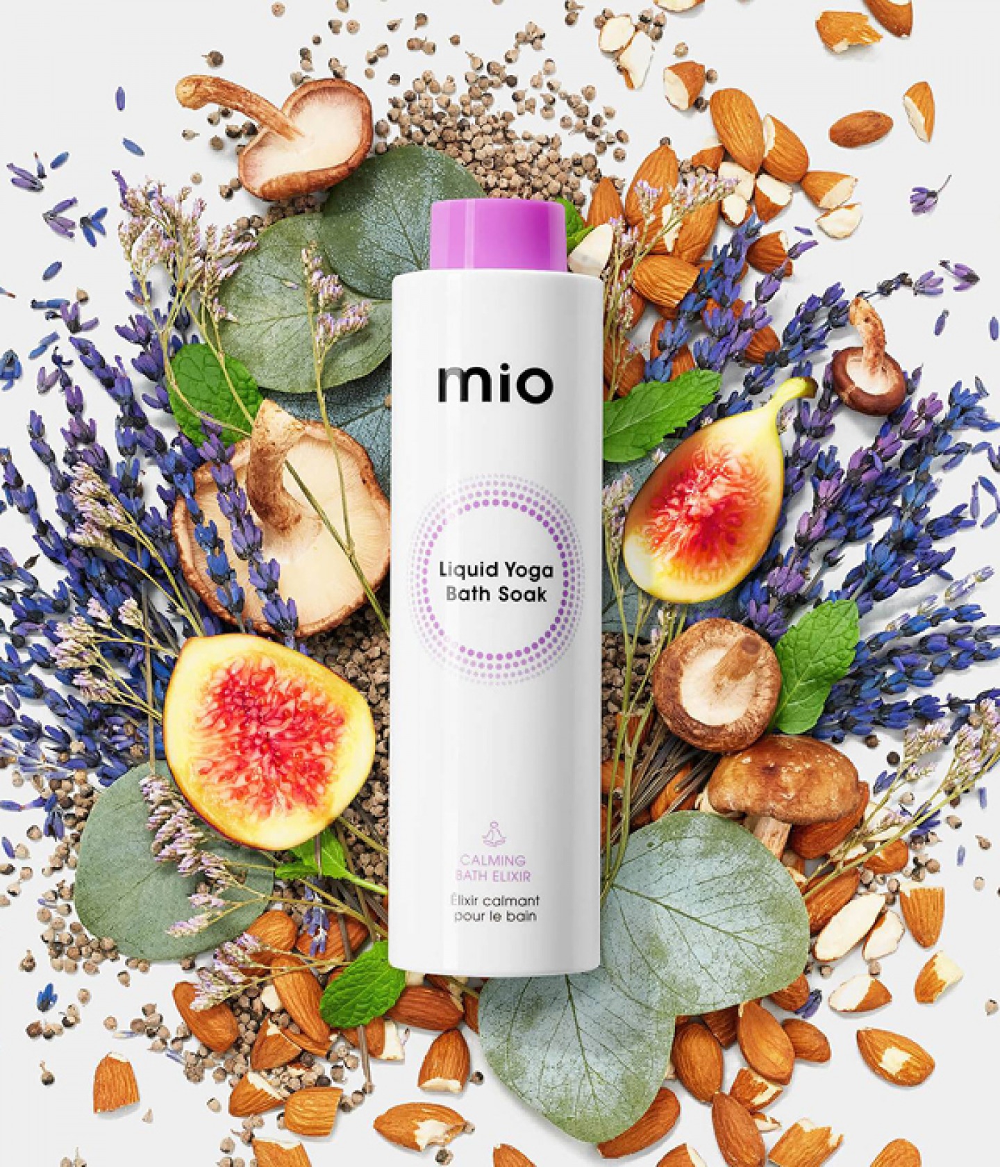 bottled beauty product lying in fruit leaves nuts and flowers