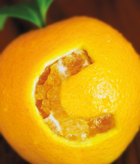 orange fruit with the letter C carved in to it