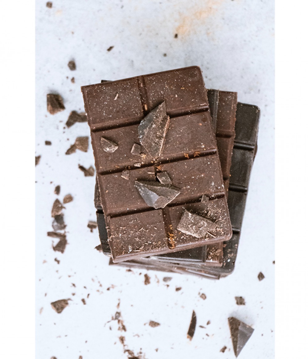 stacked chocolate bars with broken pieces on top and around