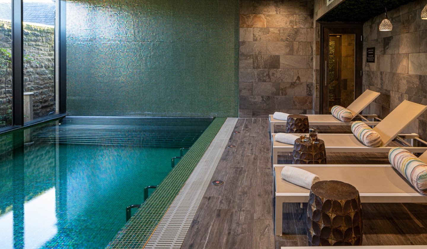 indoor spa pool with daybeds at the side