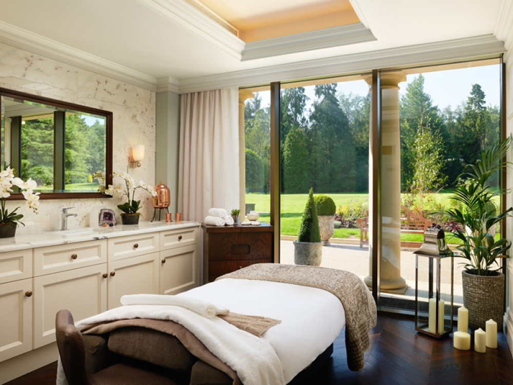 Spa room with floor to ceiling windows over looking a garden