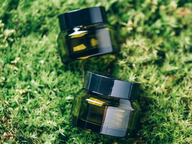 green grass with green jars on top