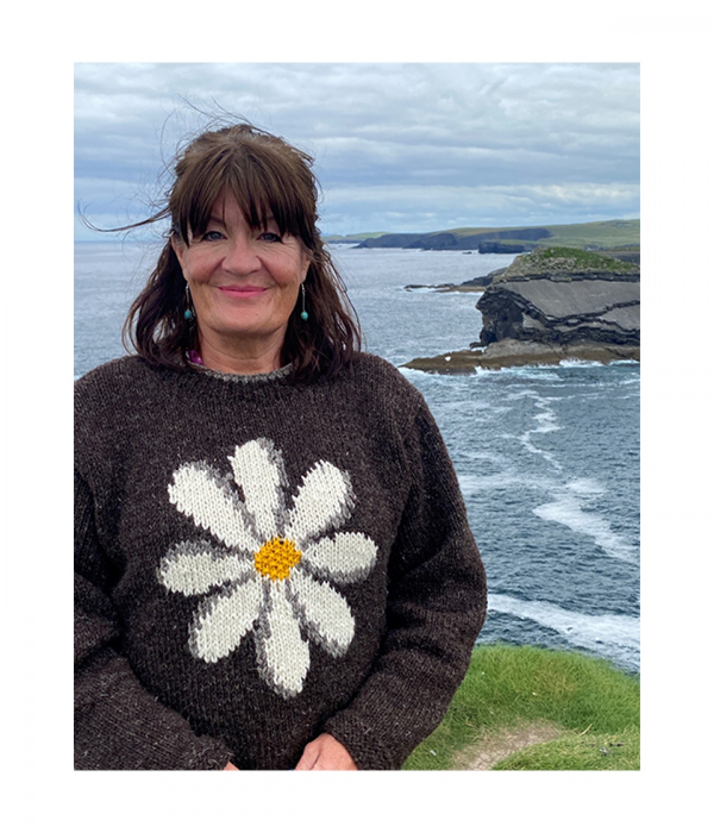 Siobhan standing with cliffs in the background