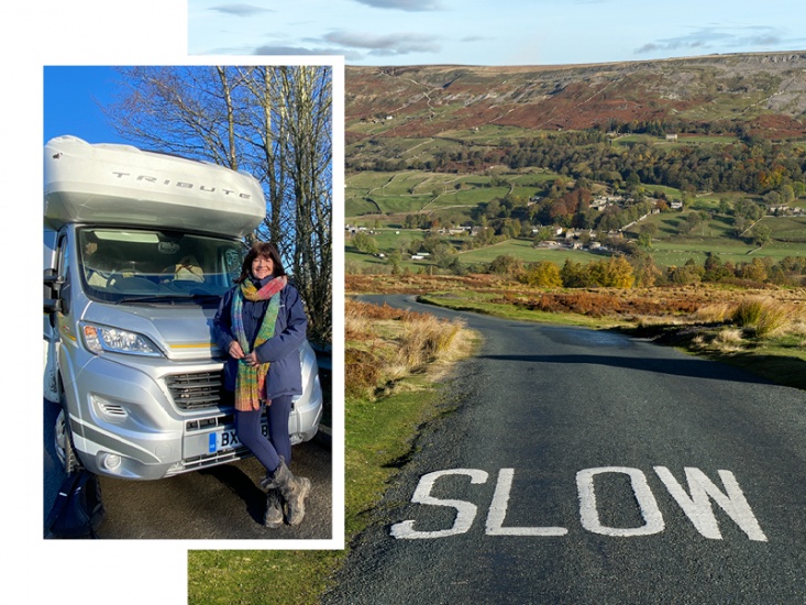 Siobhan standing in front of camper van and slow sign on road