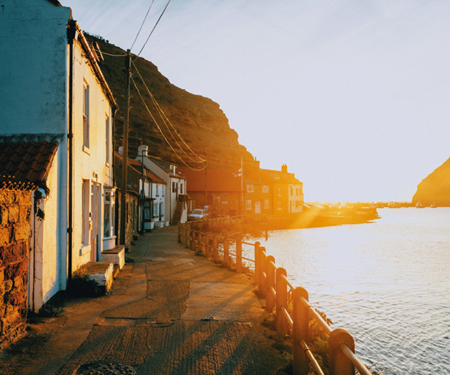 sunset over houses in a harbour