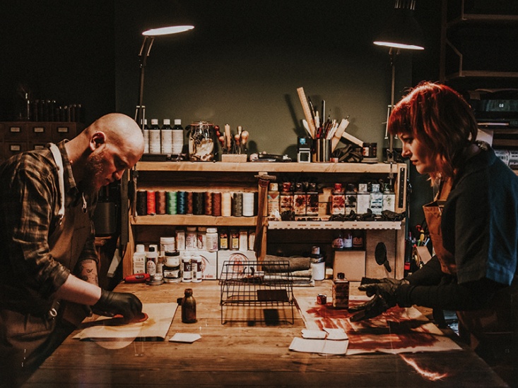 2 people hand dying leather