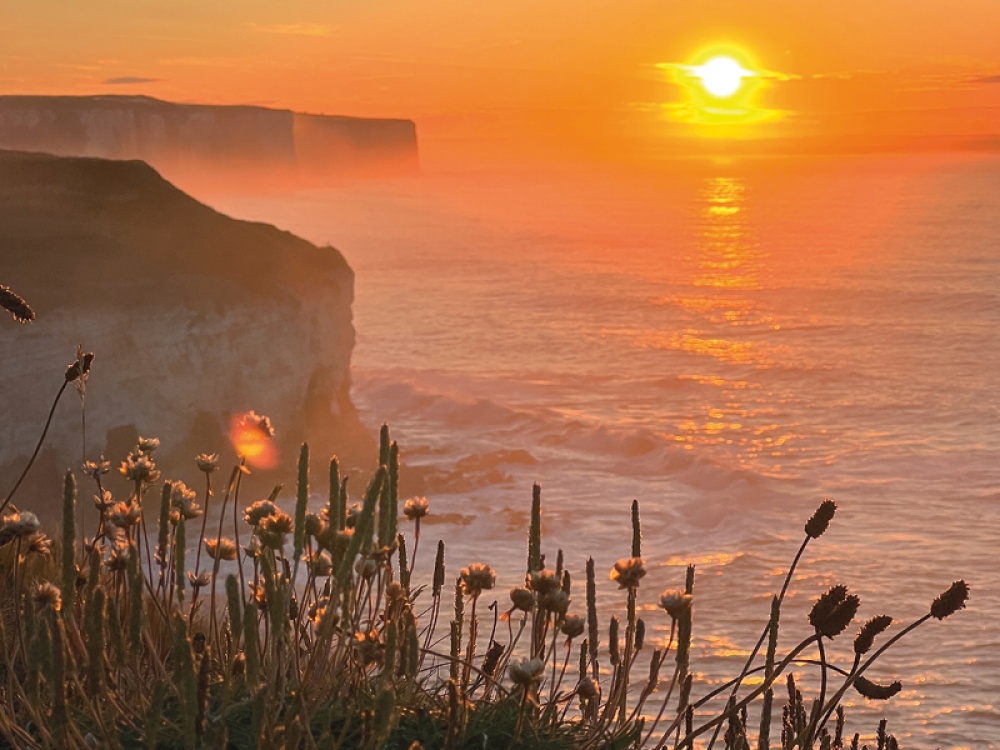 sunset over a cliff