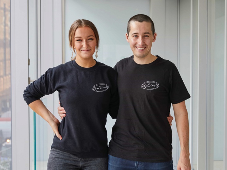 2 people smiling in back t-shirts