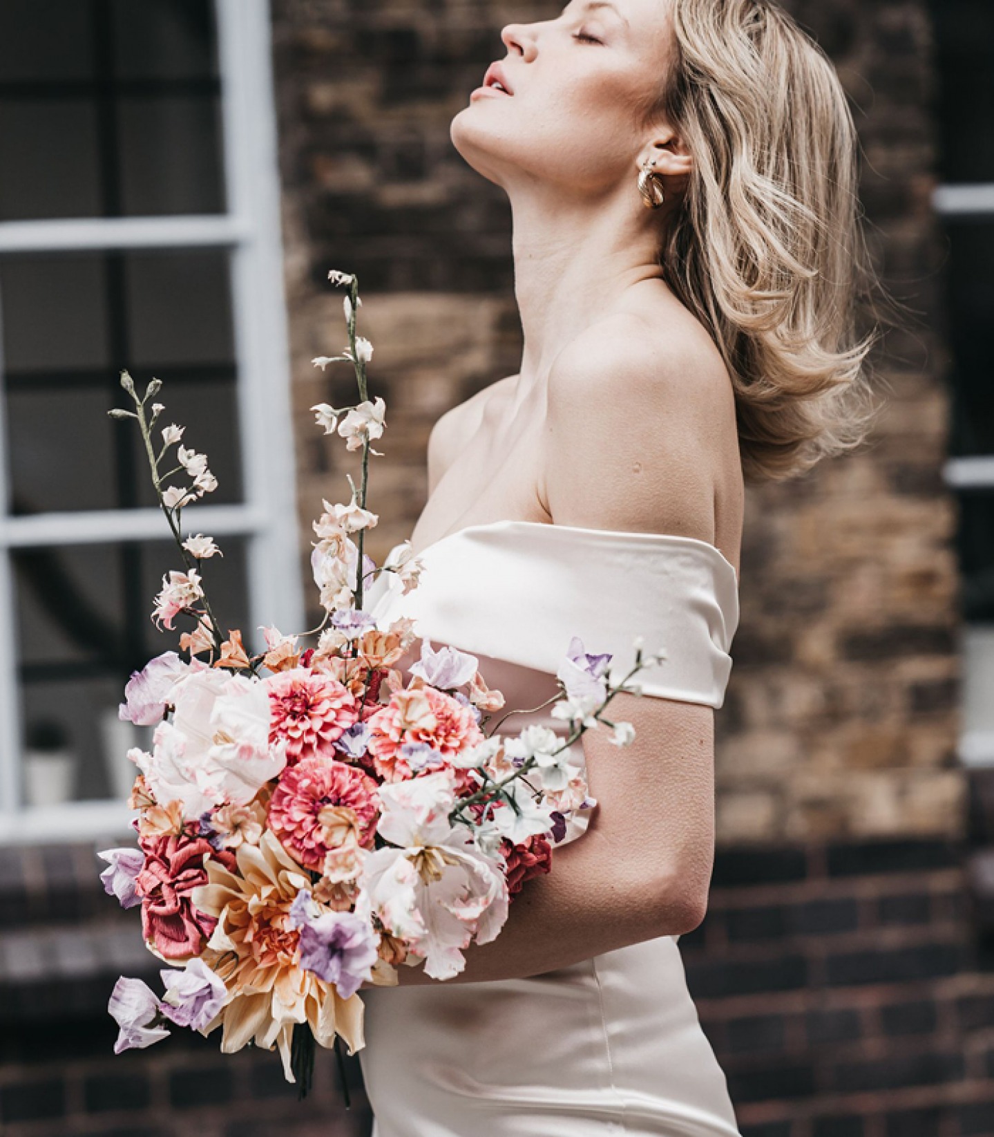 bride holding paper flower bouquet