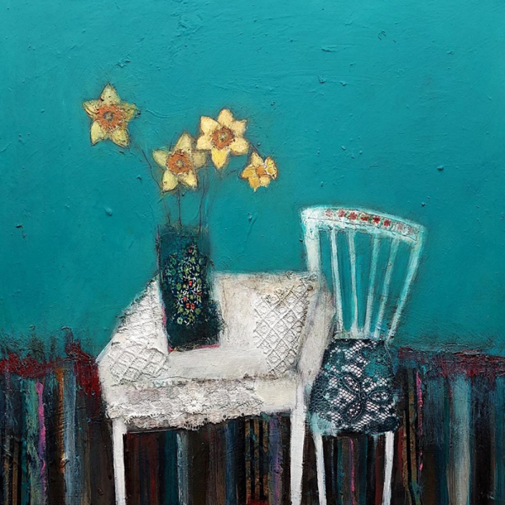white table and single chair with daffodils in a vase