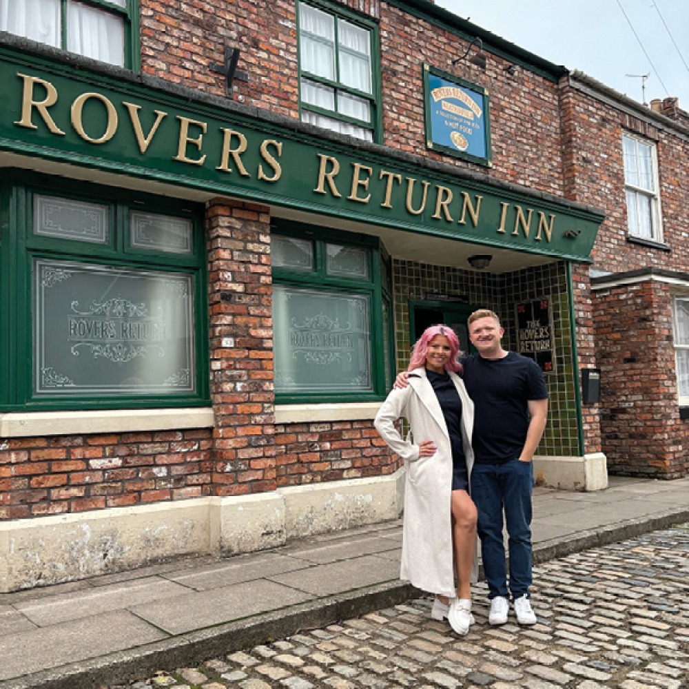 Molly and Coronation Street star Sam Aston outside the Rovers Returns pub on the Coronation Street Set