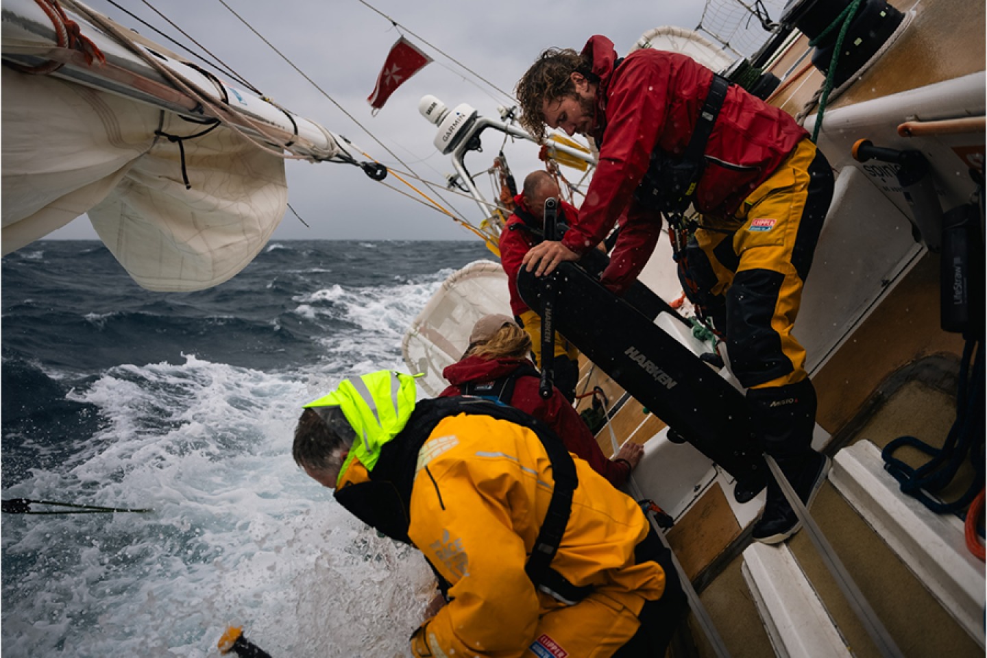 Sailors aboard yachts during Clipper race in rough seas
