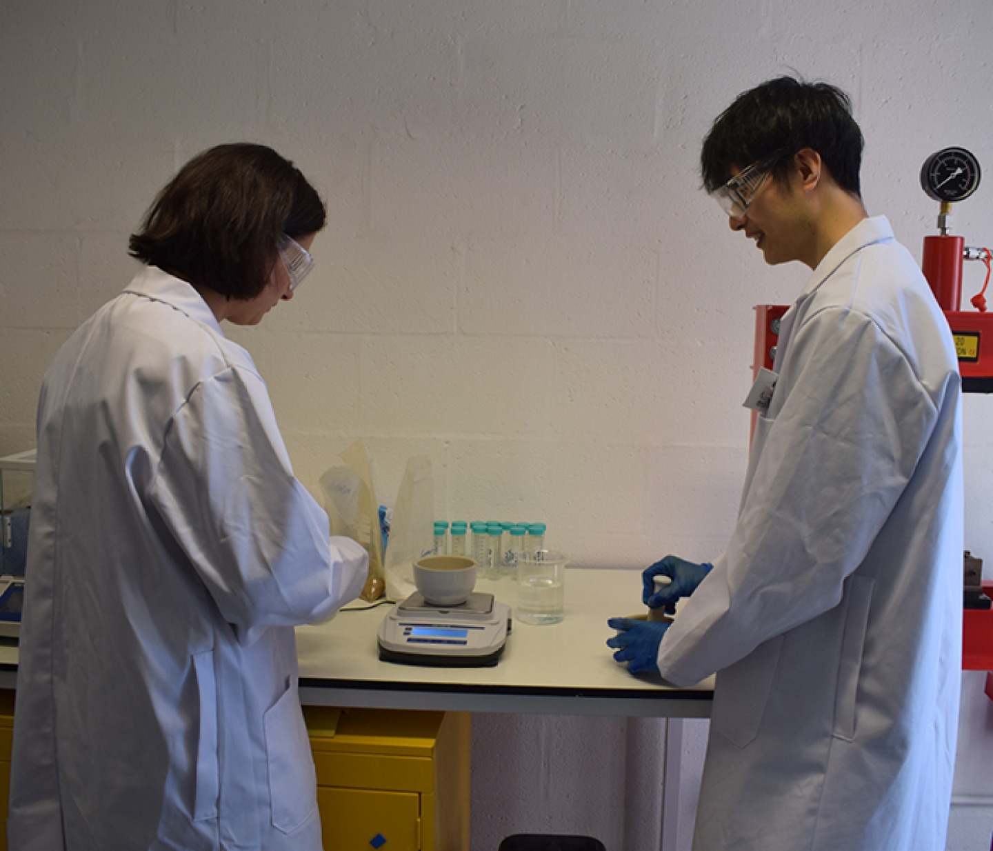 Cecilia Pesce, Principal Research Engineer and Xiang Zhang, Product Development Engineer, making samples for testing