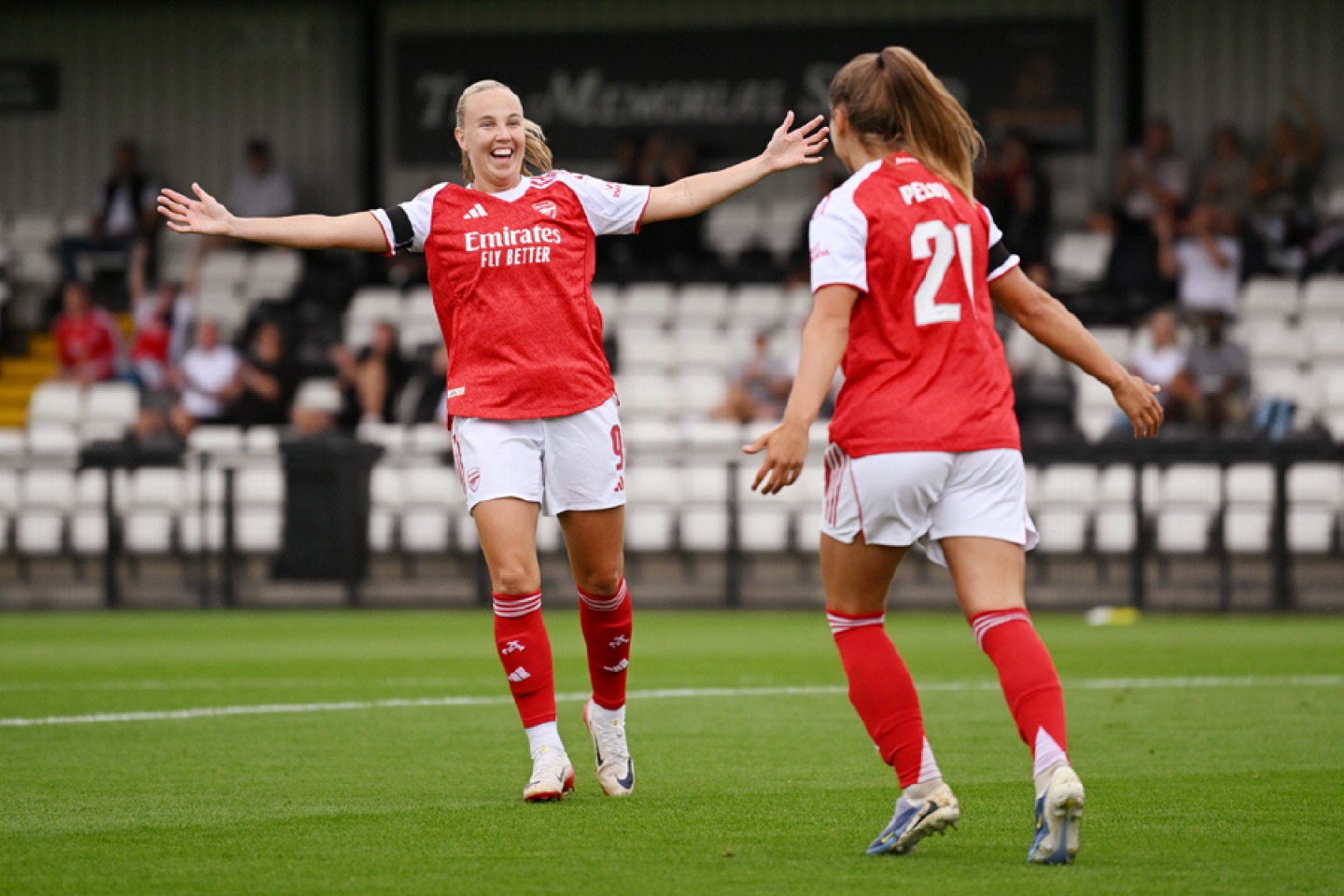 Beth Mead celebrating on the pitch with team mate. Arsenal FC - David Price