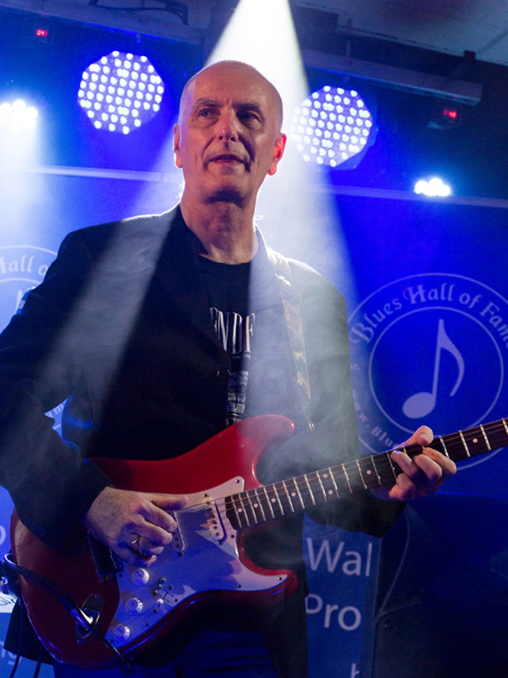Trevor playing his guitar on stage