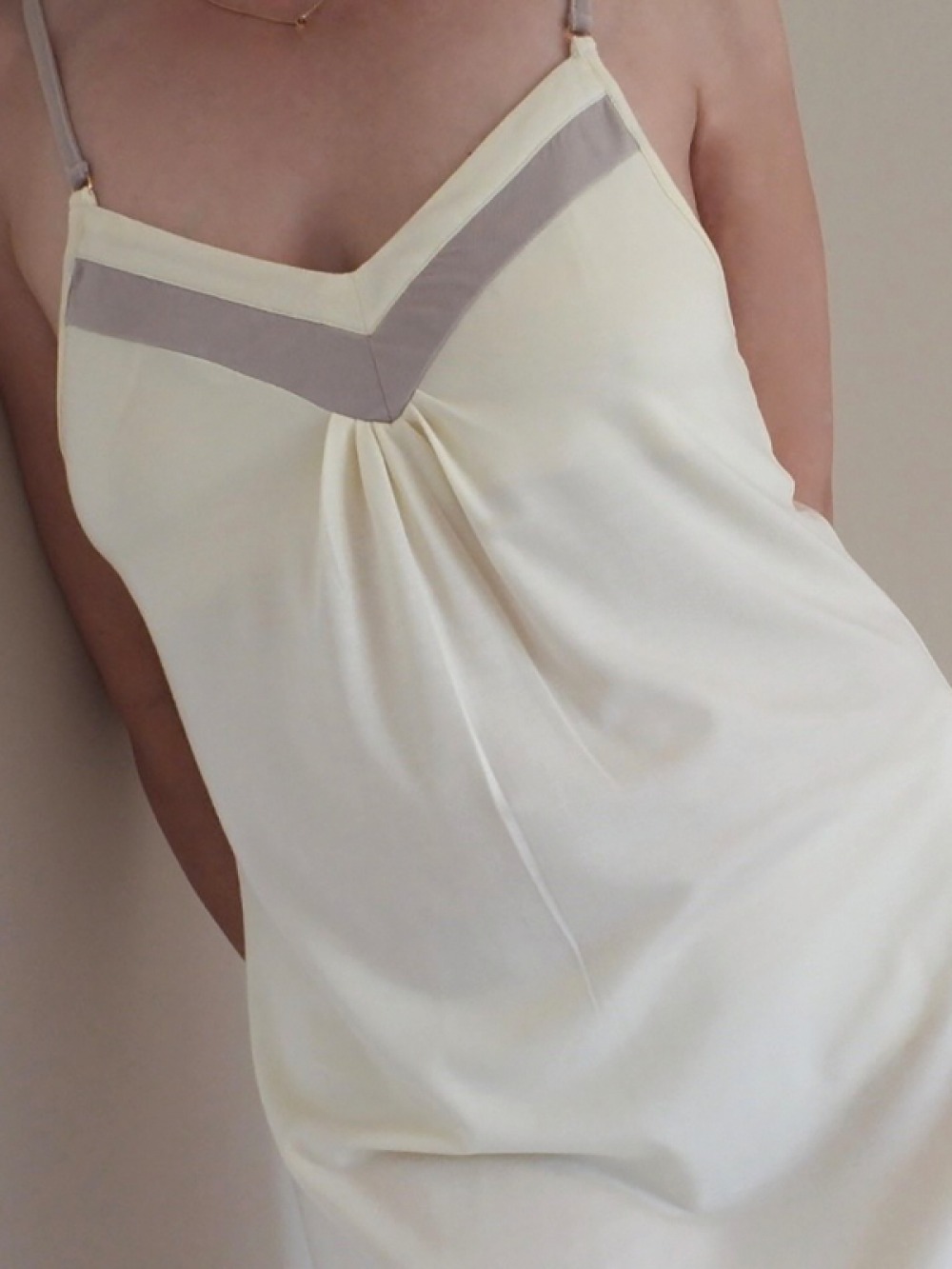 close up of model wearing cream and grey slip-style night wear