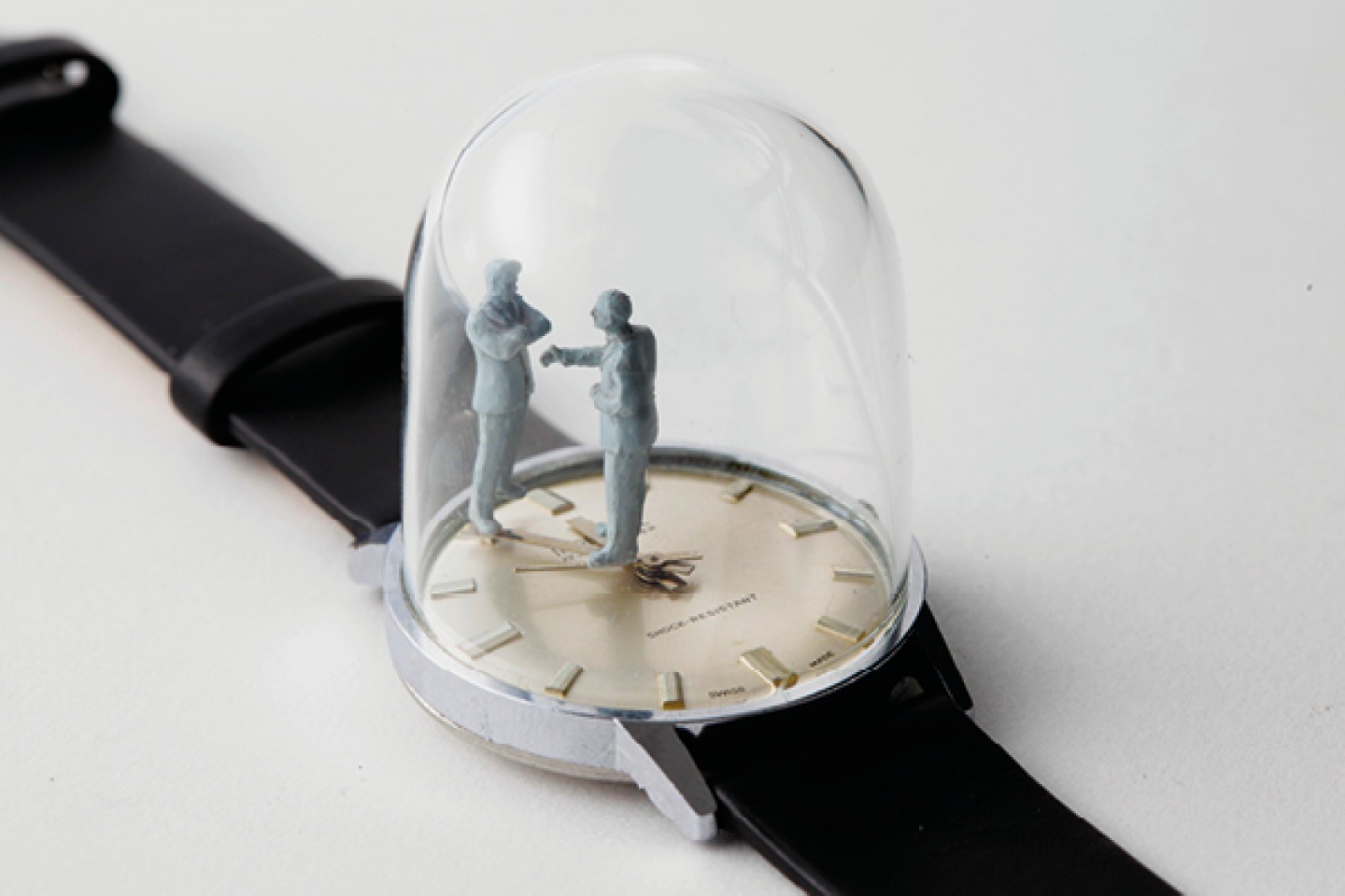 watch with 2 figures standing in a dome