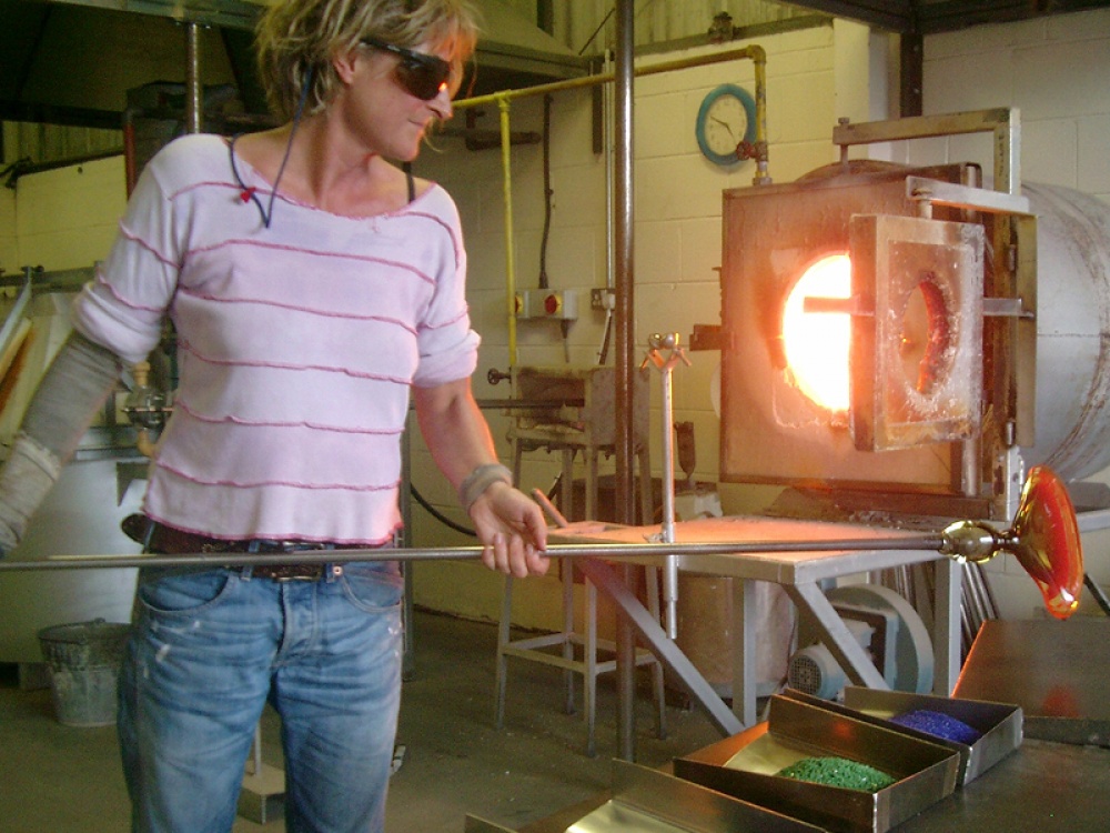Jane Charles bowing glass in her studio
