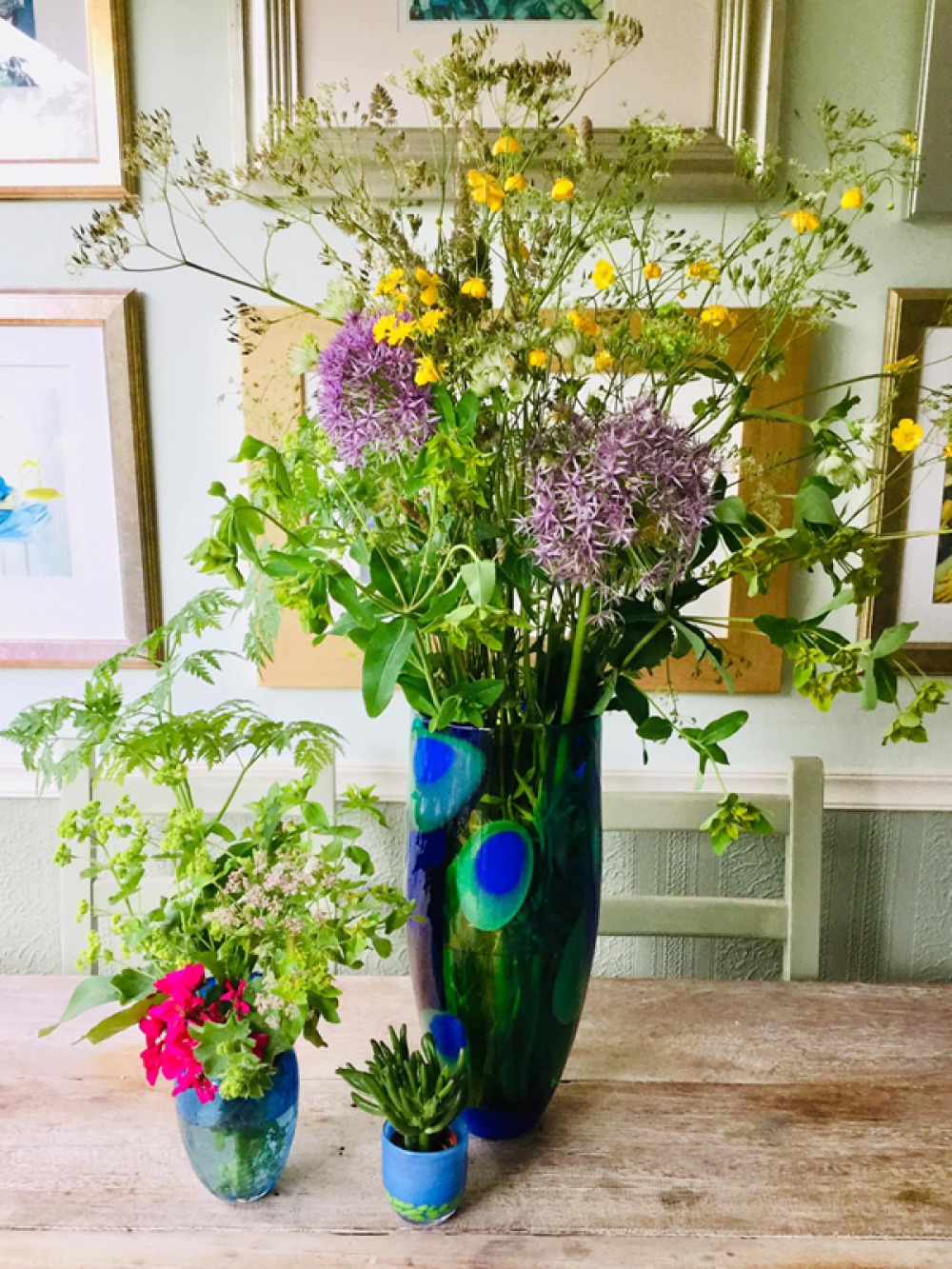 3 different size colourful vases with fresh flowers
