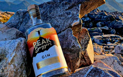 Peak Gin Bottle resting on Rocks