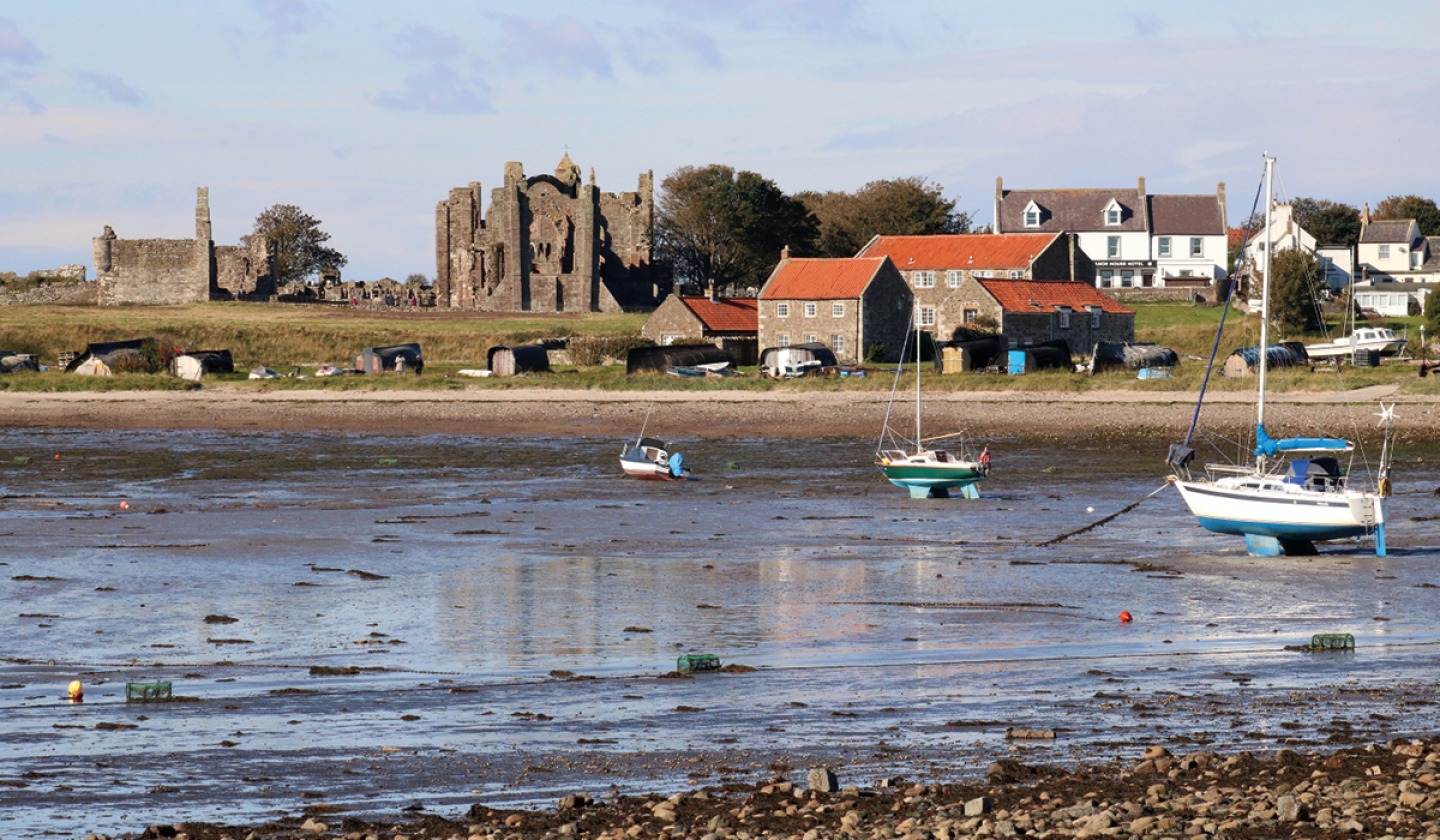 boats in the harbour while the tide is out
