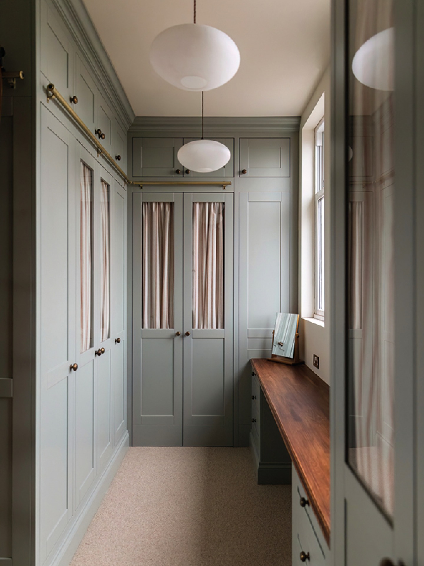 Dressing room with greige built in wardrobes