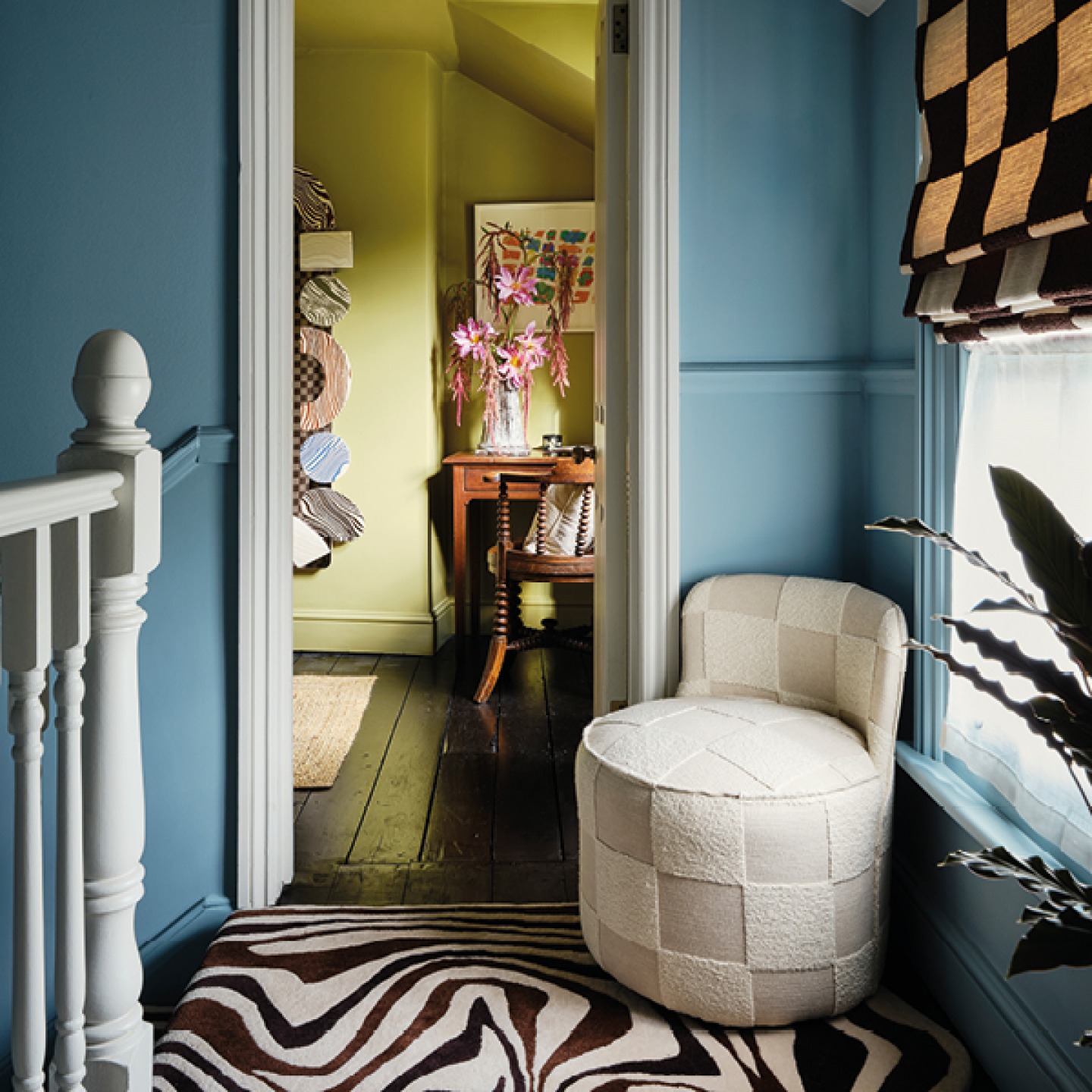 Landing area with open door, decorated in bold colours and fabrics