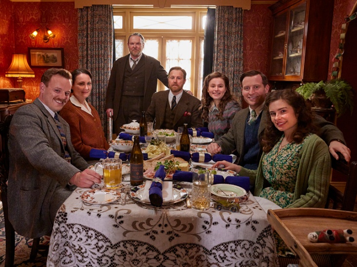 cast sitting around table