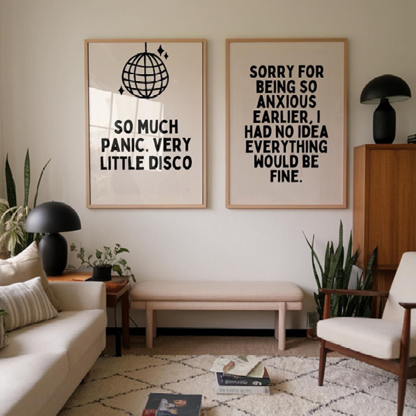Two large framed prints hanging on a neutral wall