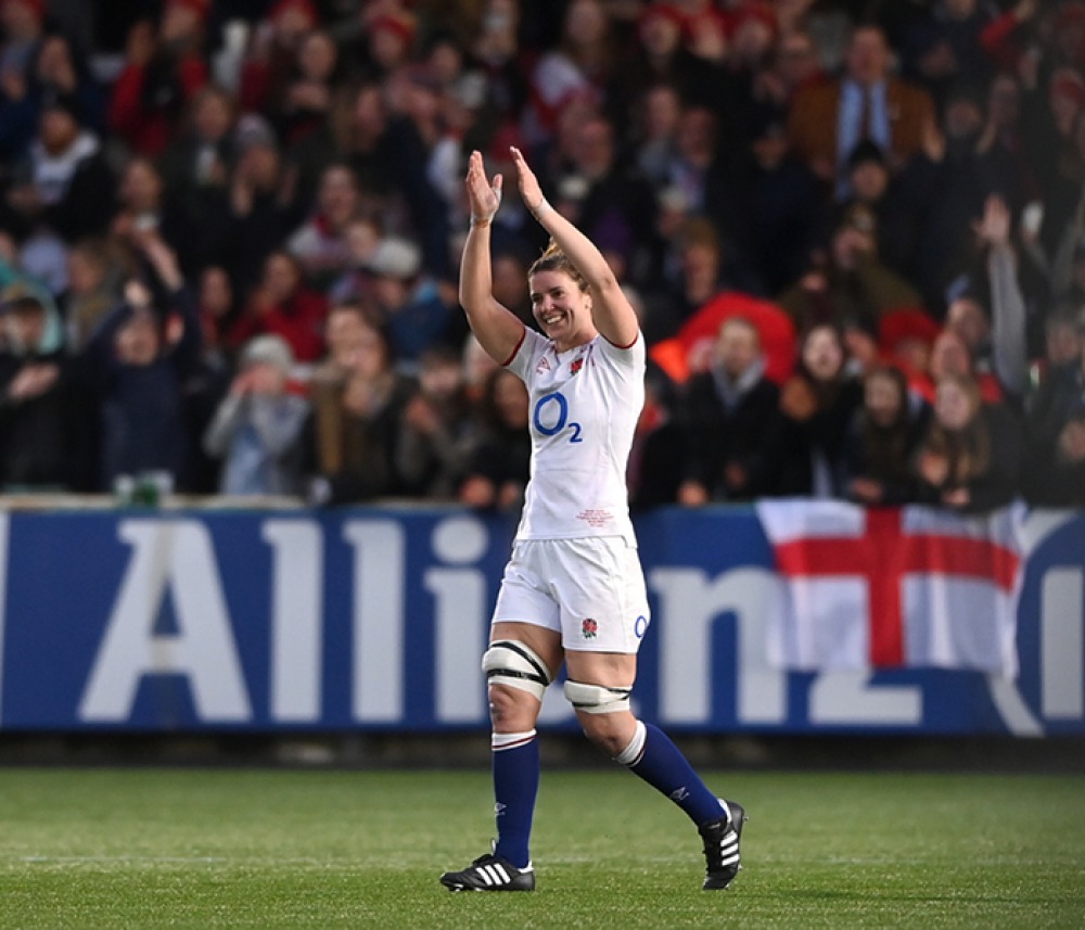 Sarah Hunter on the pitch in her England strip cheering at the crowd