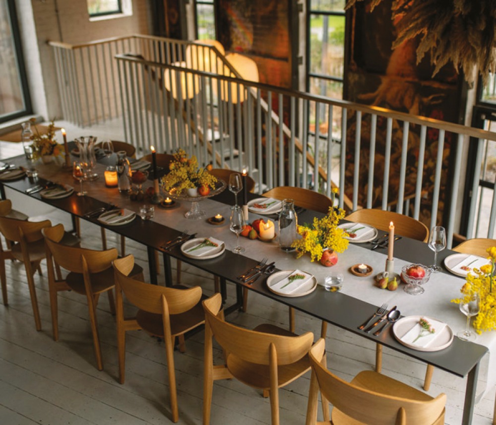 Large table set with candles, flowers and fruit centre pieces