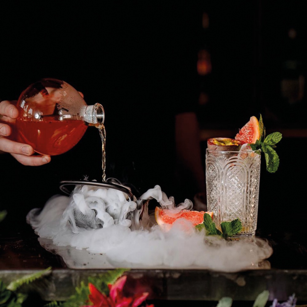 cocktail being poured over dry ice