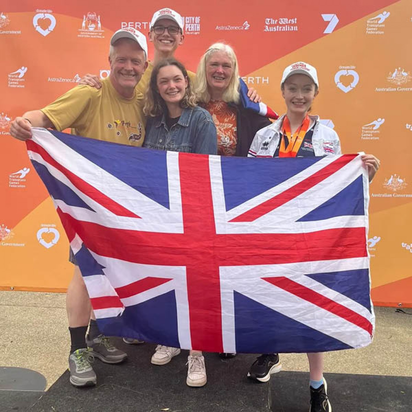 Charlotte with her family holding GB Flag