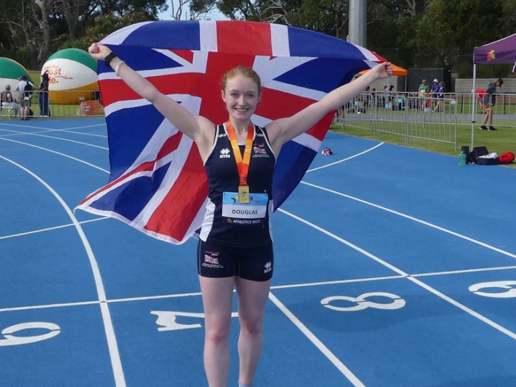 Charlotte Douglas with medal and holding GB Flag