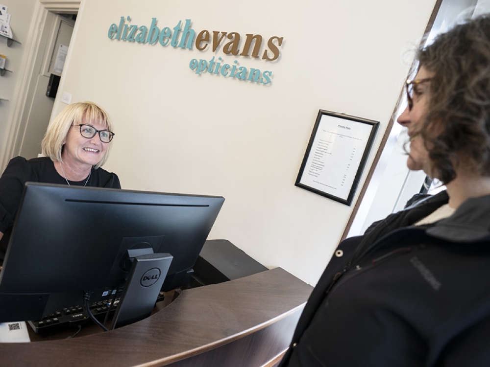 receptionist checking in a client