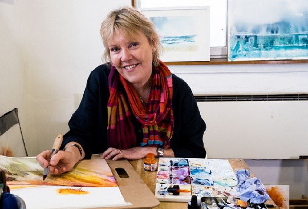 Ione Harrison painting in her workshop