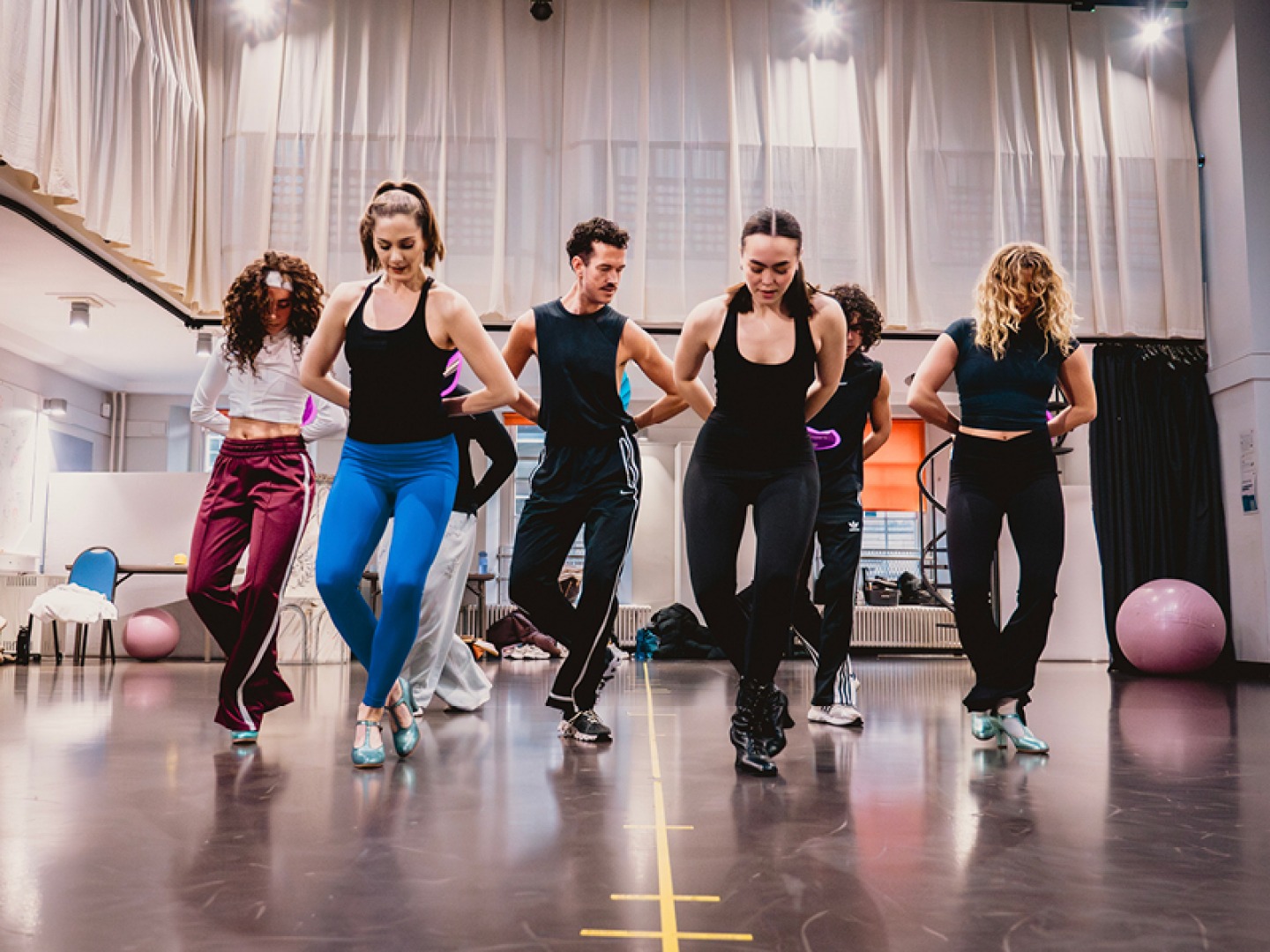 Actors learning routine in rehearsals