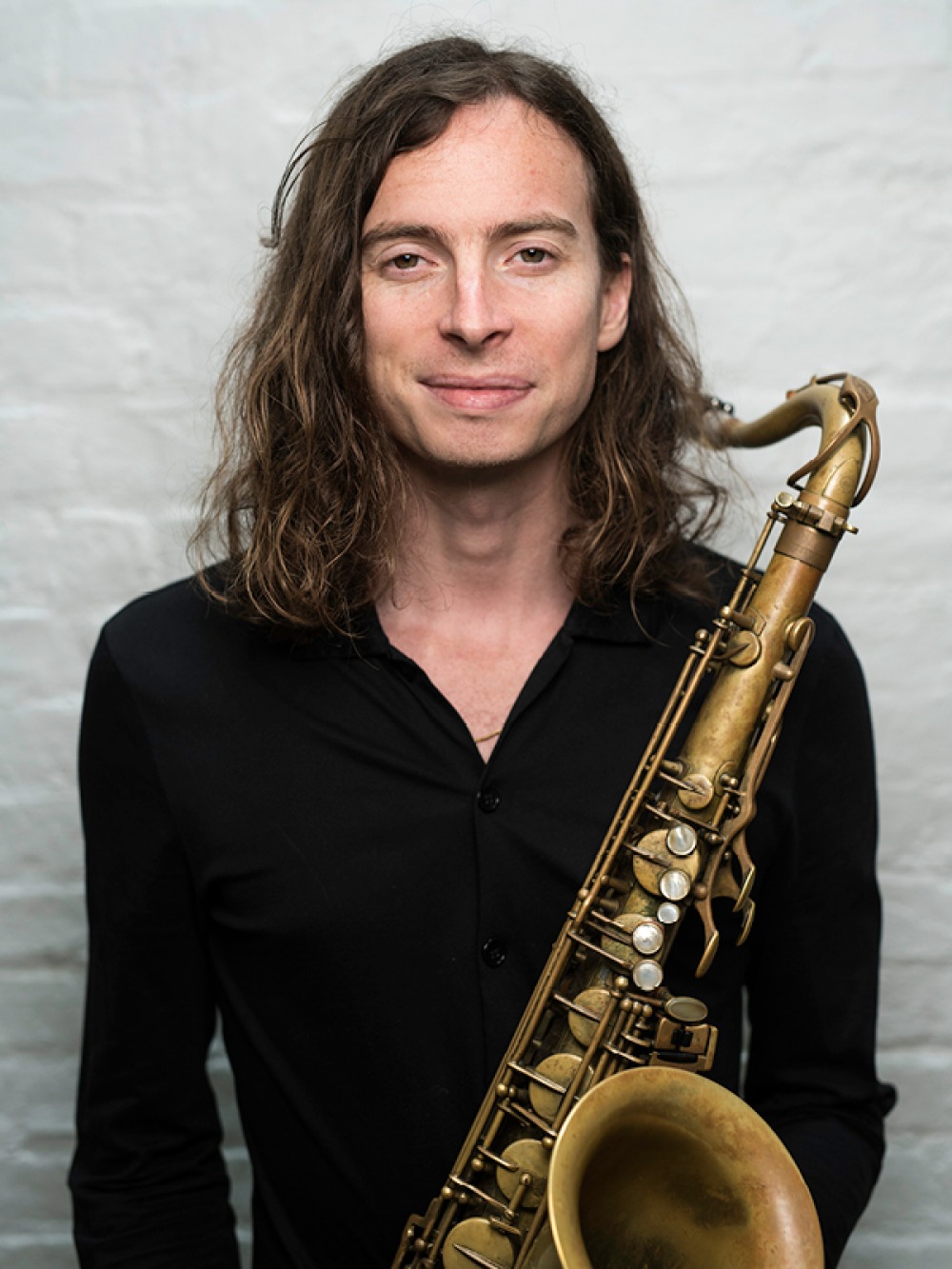 John Waugh holding saxophone