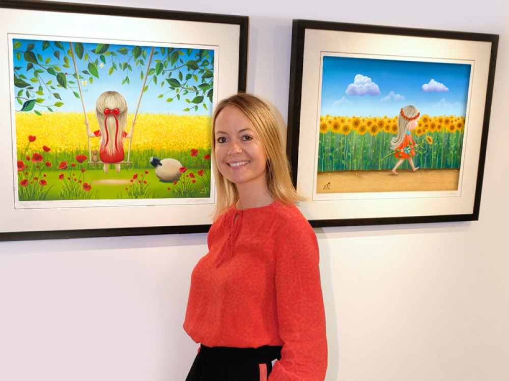 lucy standing with her paintings