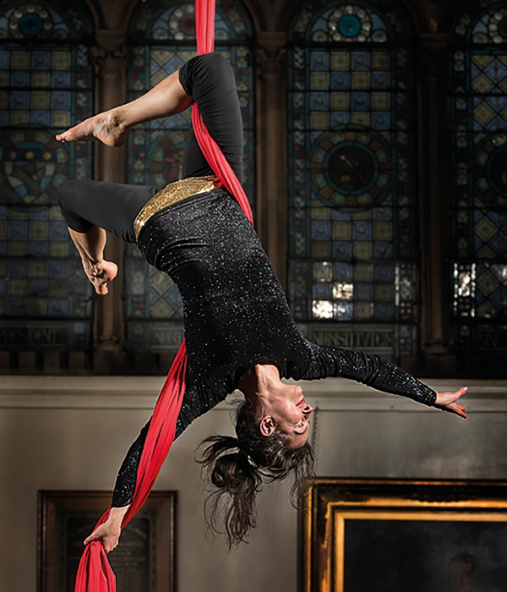 aerialist Lynn Campbell hanging upside down