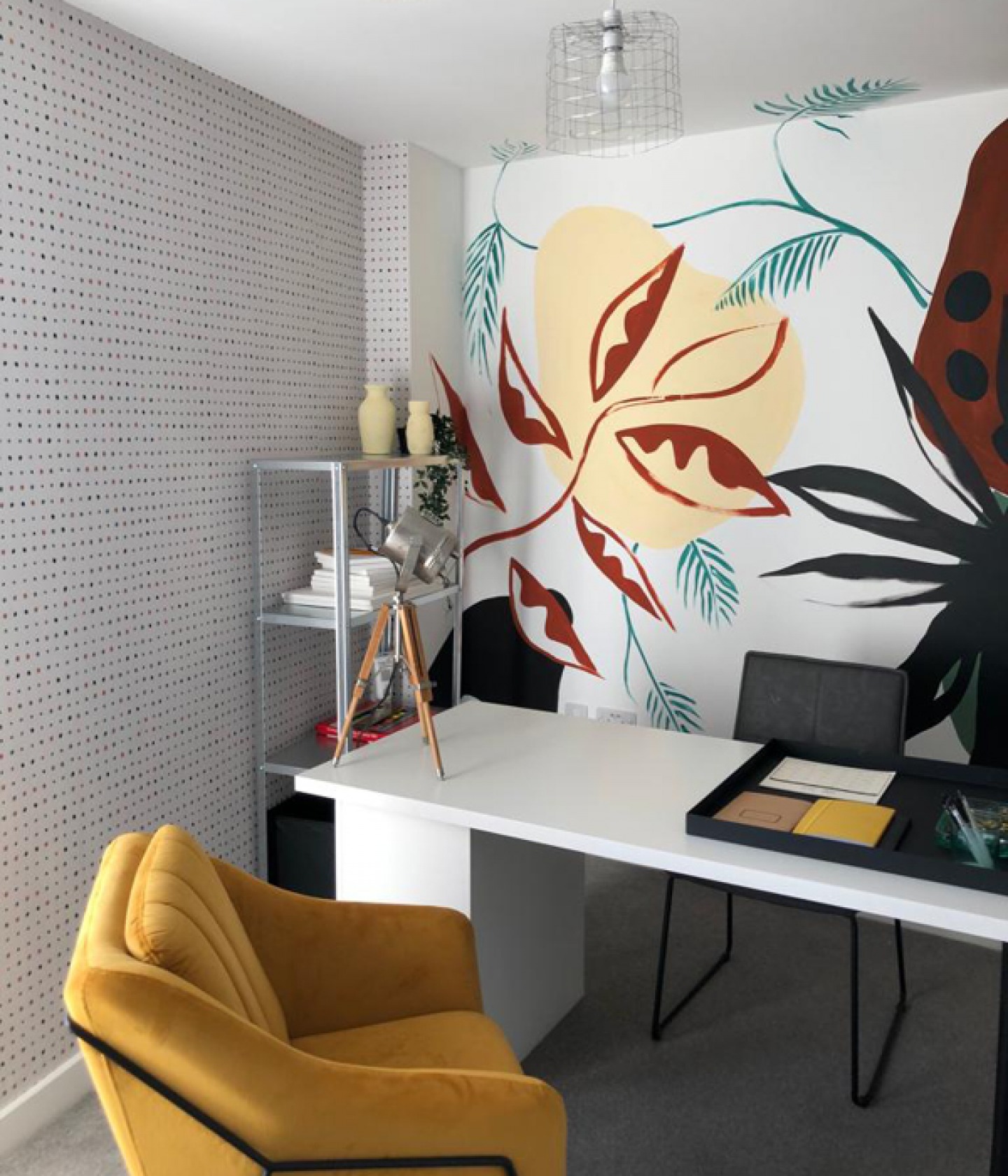 Office decorated with large print wallpaper and mustard coloured seat