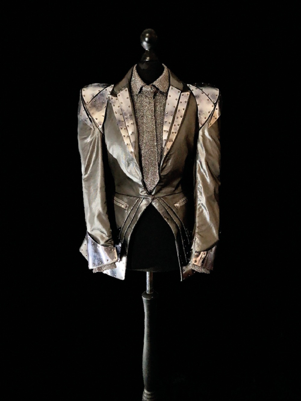 dress making bodice with metallic jacket, shirt and tie. on Black background